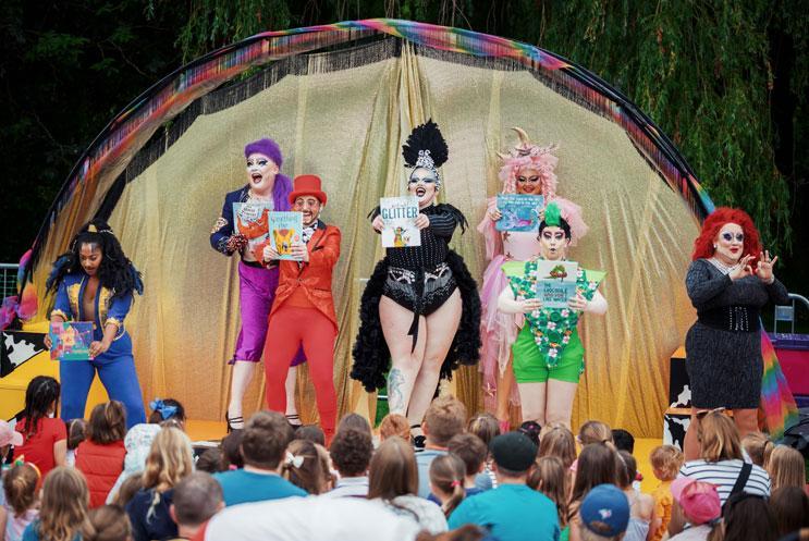 Drag artists performing to a crowd outdoors